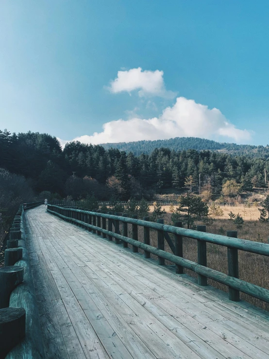 a road surrounded by some hills and trees