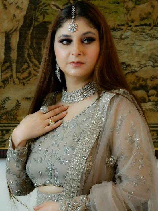 a woman in a silver outfit poses for the camera