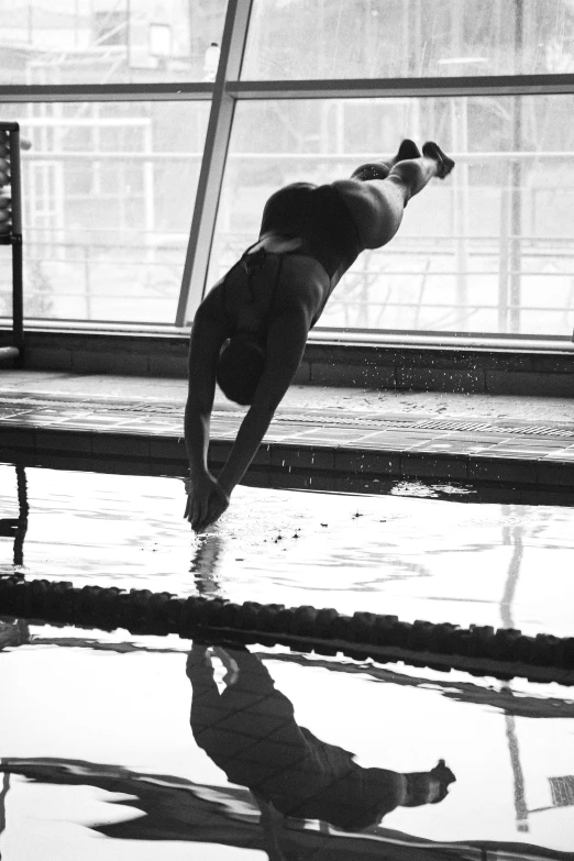 black and white pograph of a young person diving