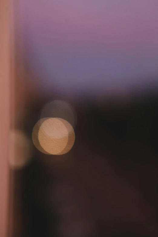 blurred image of a bright purple sky over buildings