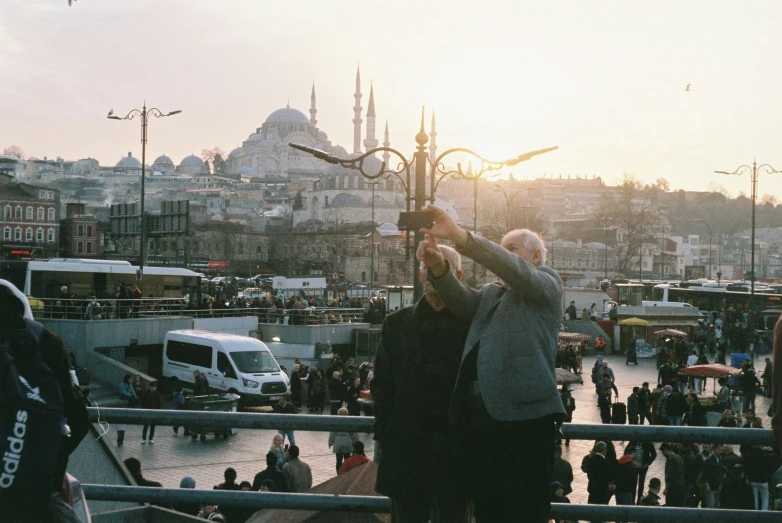 two men standing by each other holding up a glass