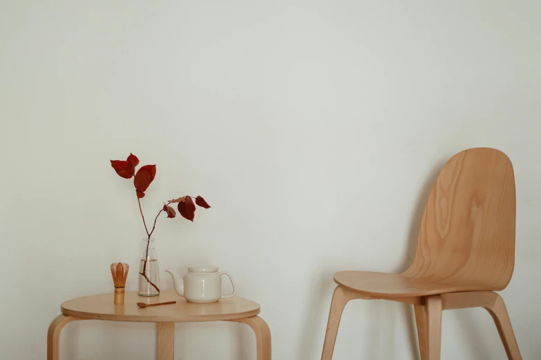 a wooden chair sitting next to a wooden table