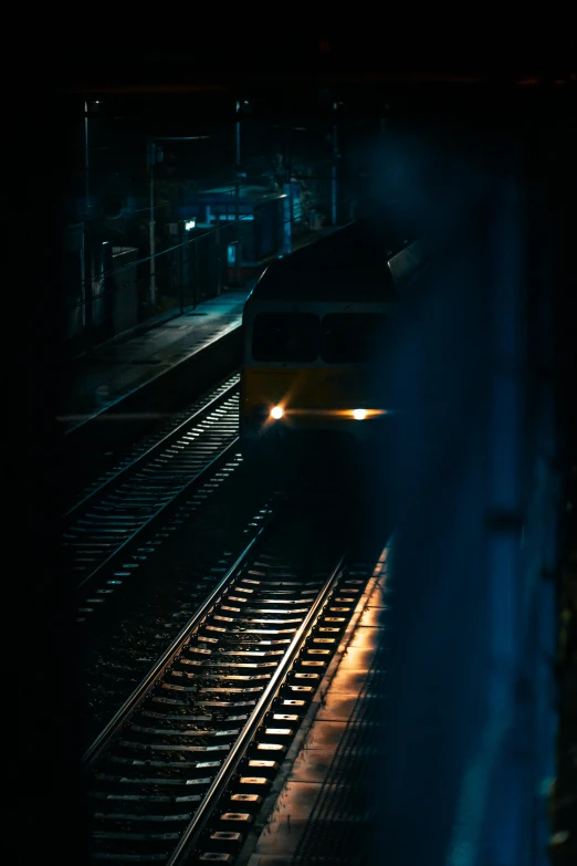 a night time po of a train coming in to a station