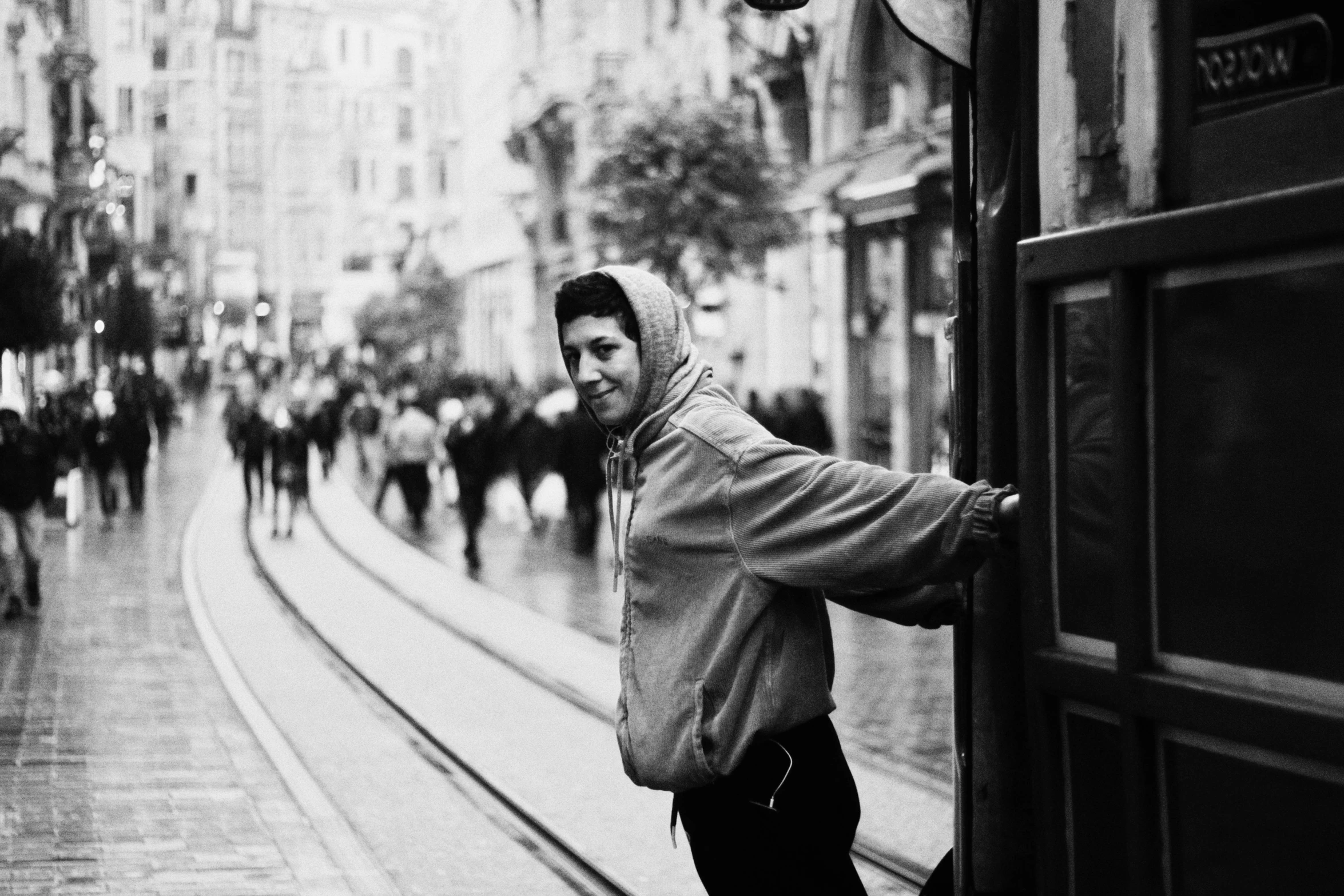 a man looking down from a subway train