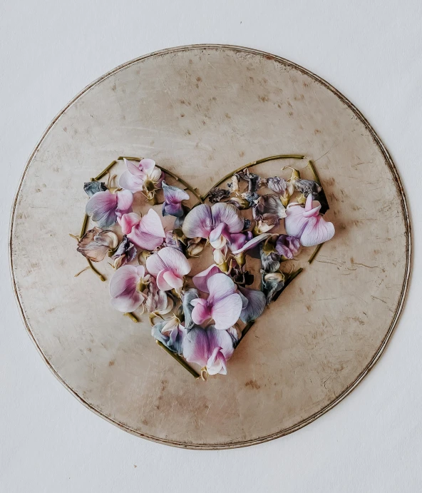 a heart shaped piece of food with floral toppings