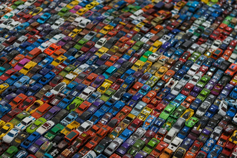 a large collection of colorful car models are displayed