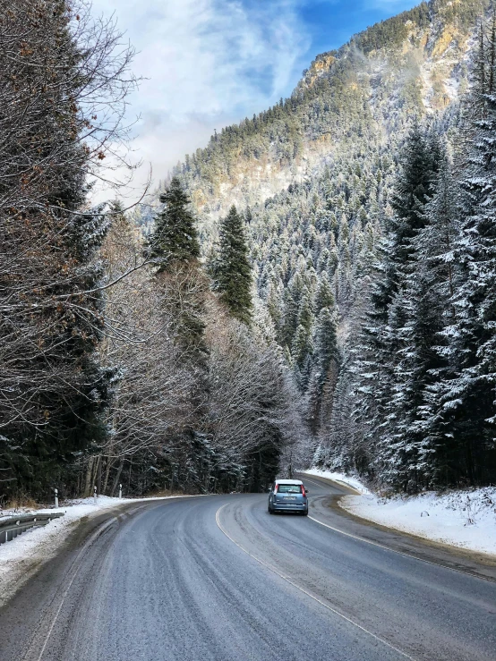 car driving down the snowy road on a winter day