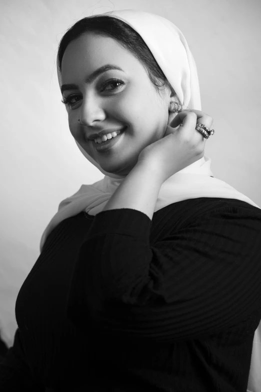 a woman with a head scarf is smiling