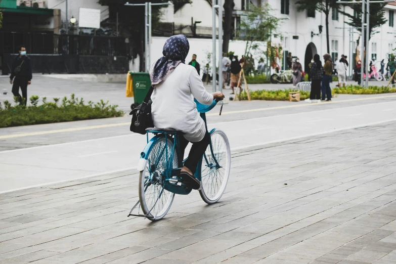 a woman is riding her bike down the street