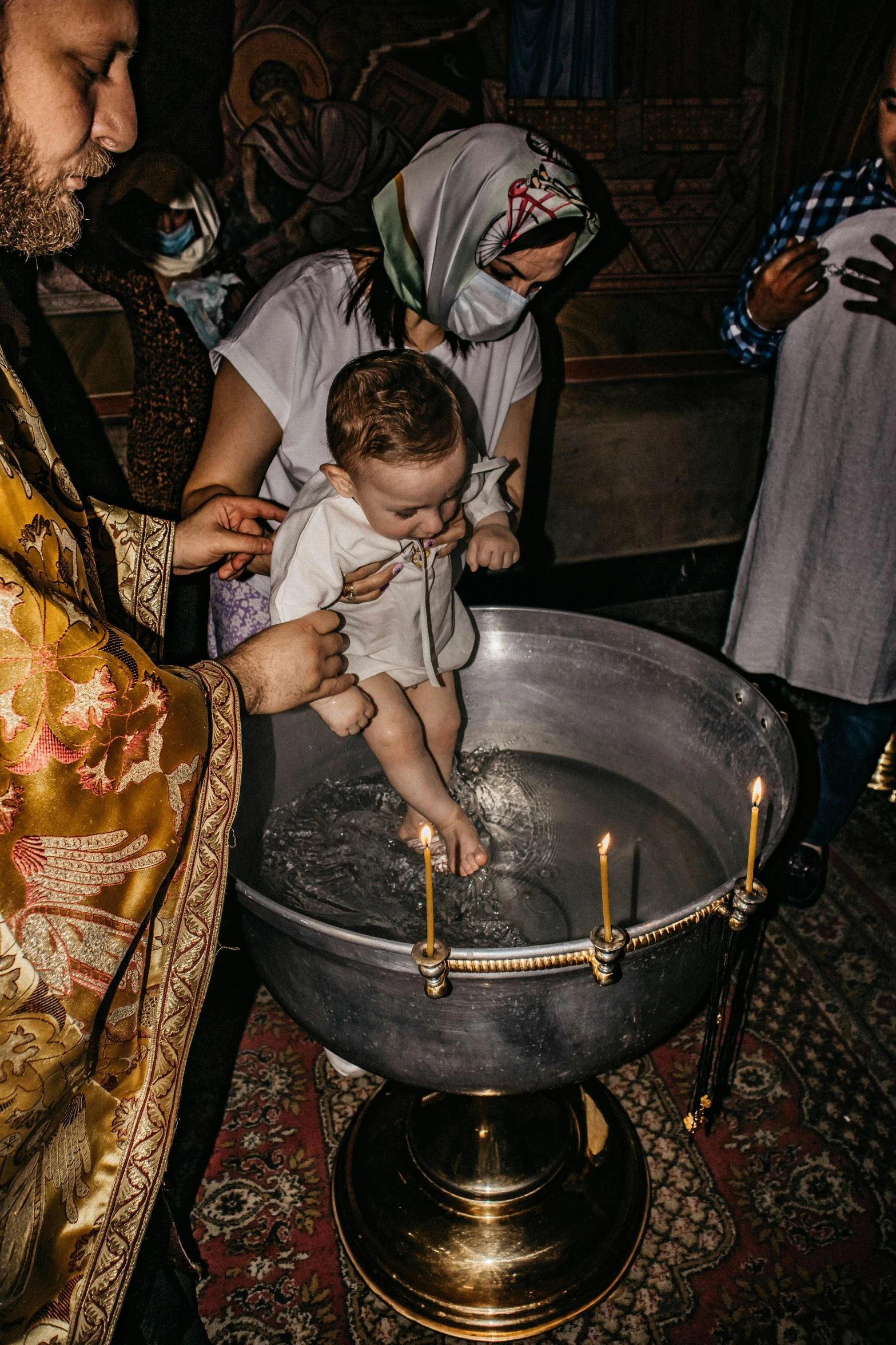 a baby in a bucket being bathed with a lot of liquid