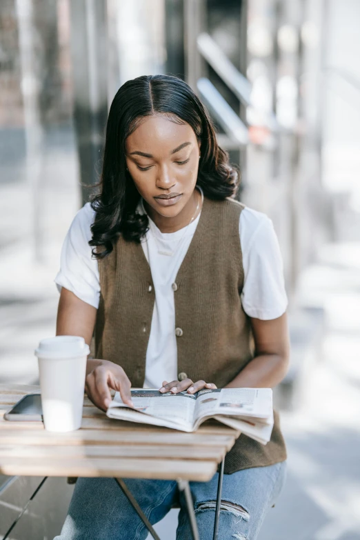 a person is sitting at a table reading