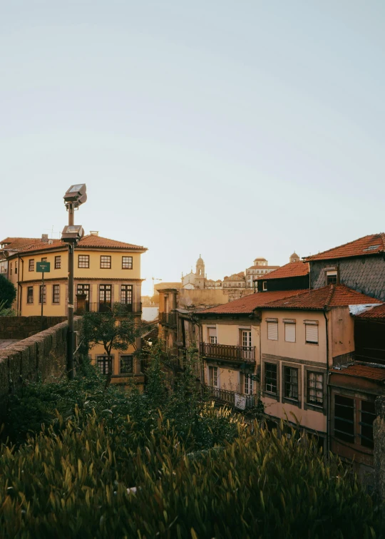 a city with tall buildings with balconies and a satellite dish on top