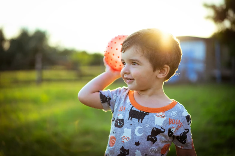 a young child is playing frisbee in a field