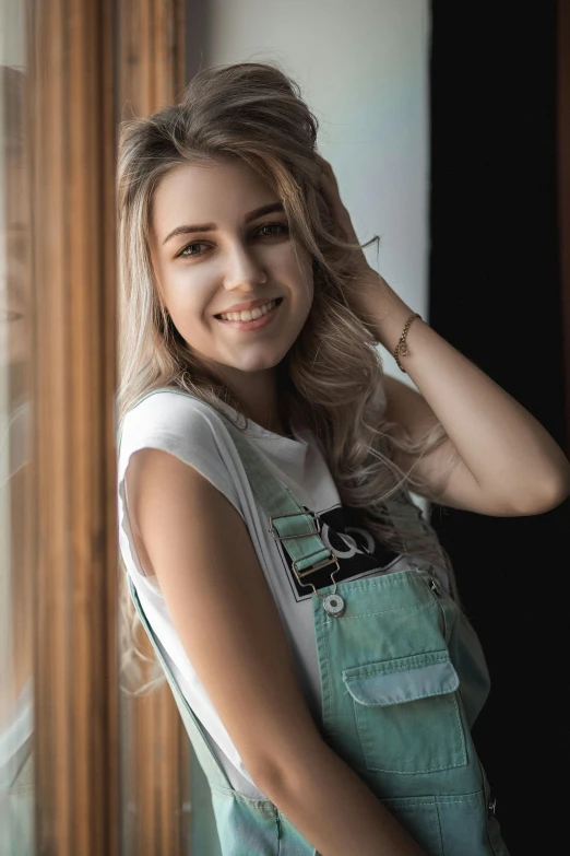 a girl with long hair standing in front of a window