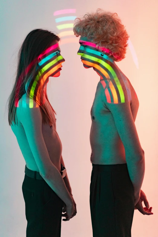 two people wearing neon colored neon light in their heads