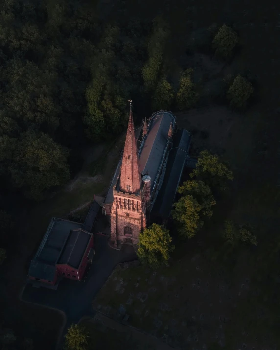 an aerial view shows a gothic structure with a tower