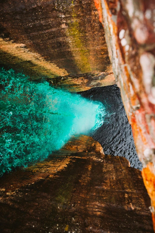 a blue substance is emerging from the water in a cave