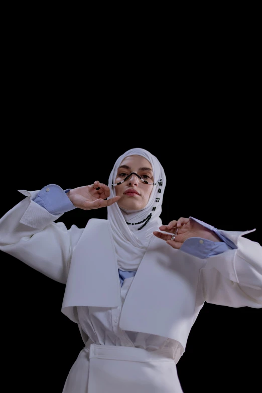 a person posing with a scarf and wearing glasses