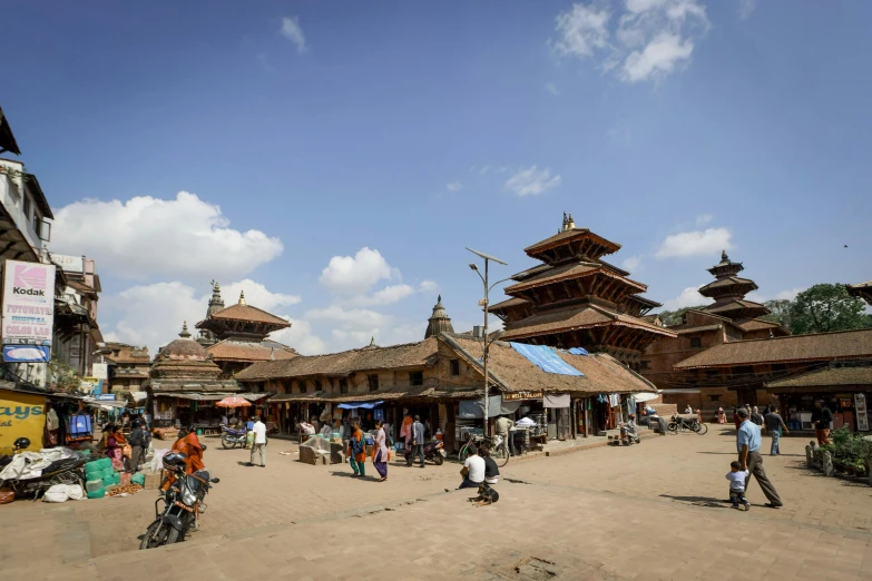 a bunch of people walk in front of several structures