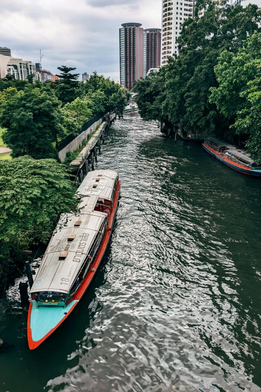 a boat is in the middle of a river near buildings