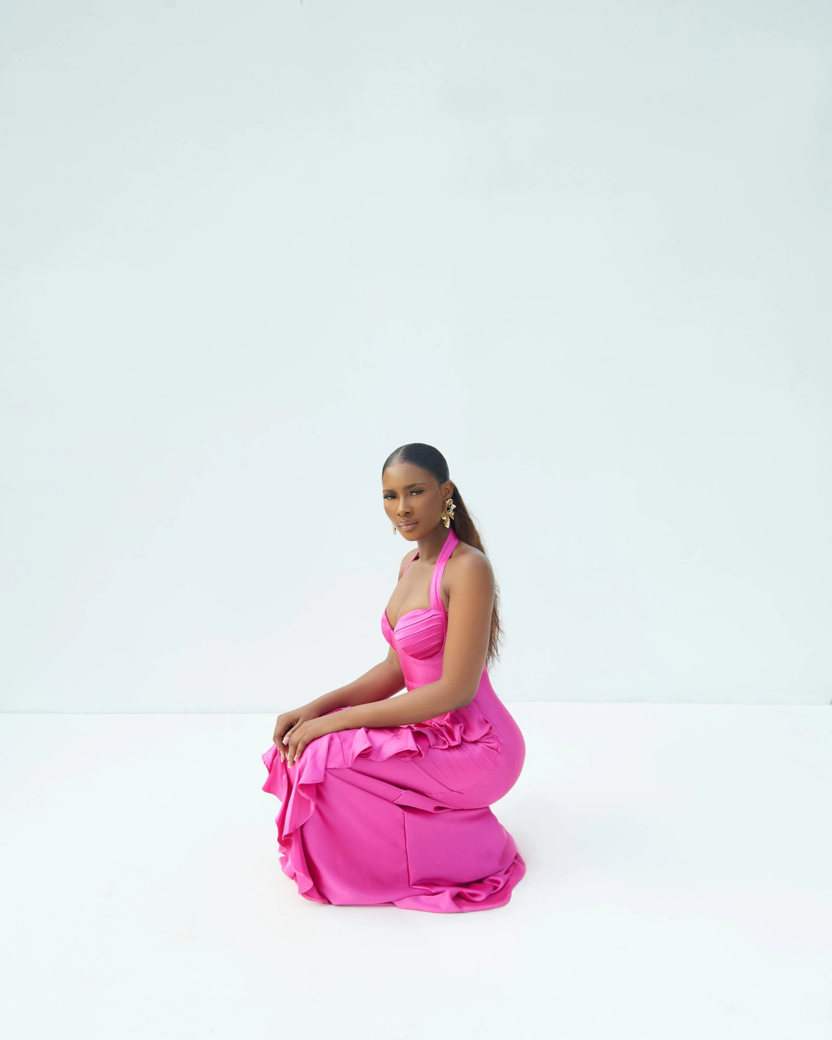 a woman sitting on the ground wearing pink