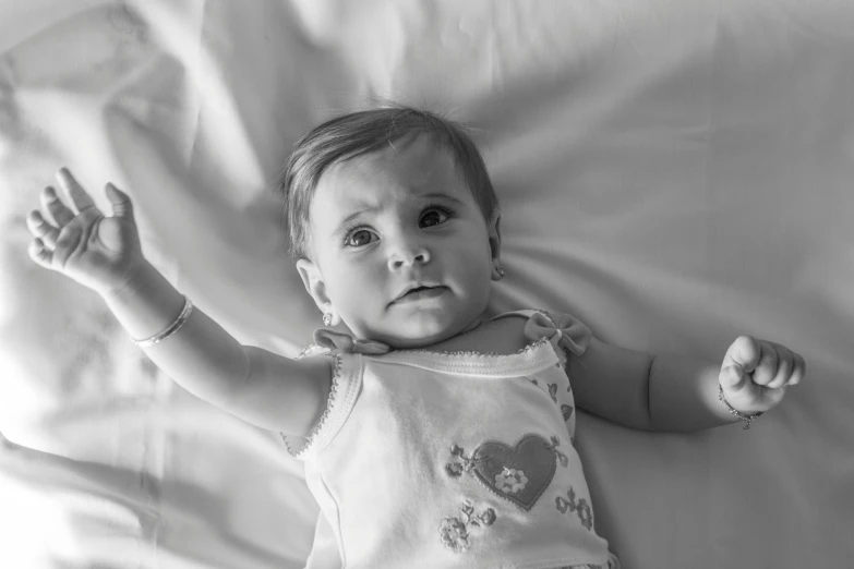 a black and white po of a toddler in a bed