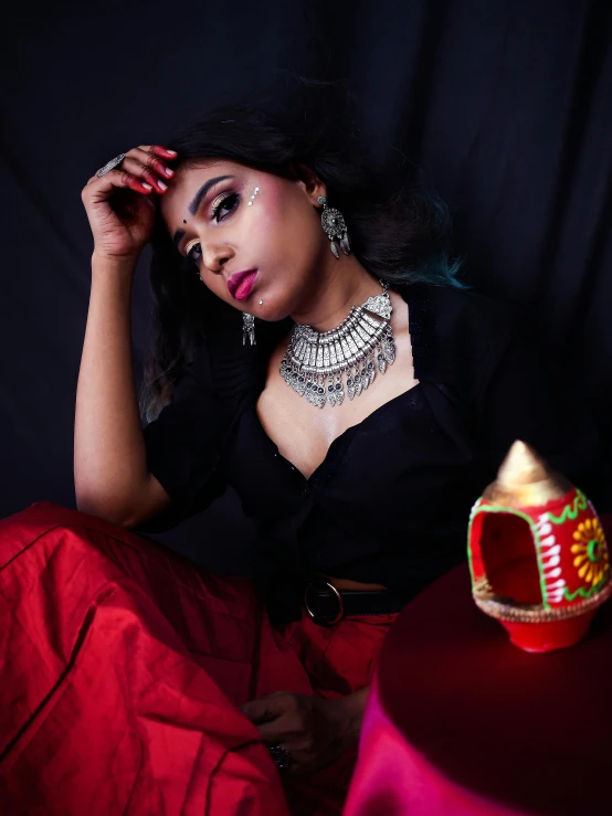 a woman sitting on a chair with some jewelry