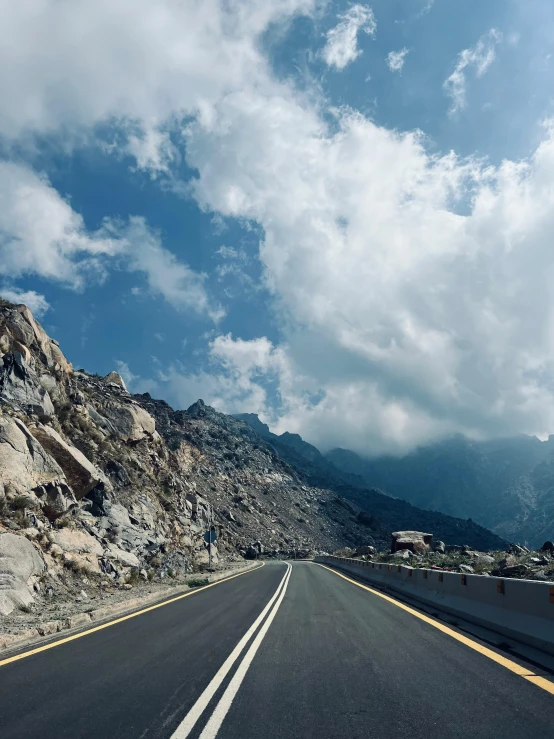 a highway running past a large mountainous landscape