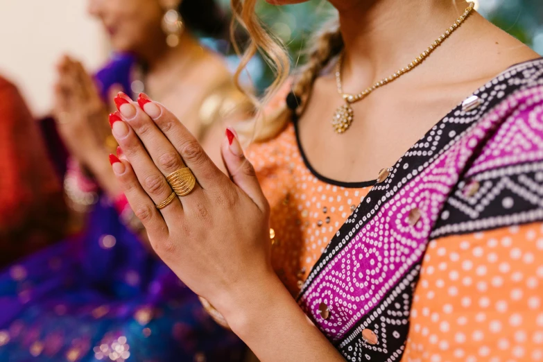 a woman wearing rings on her fingers