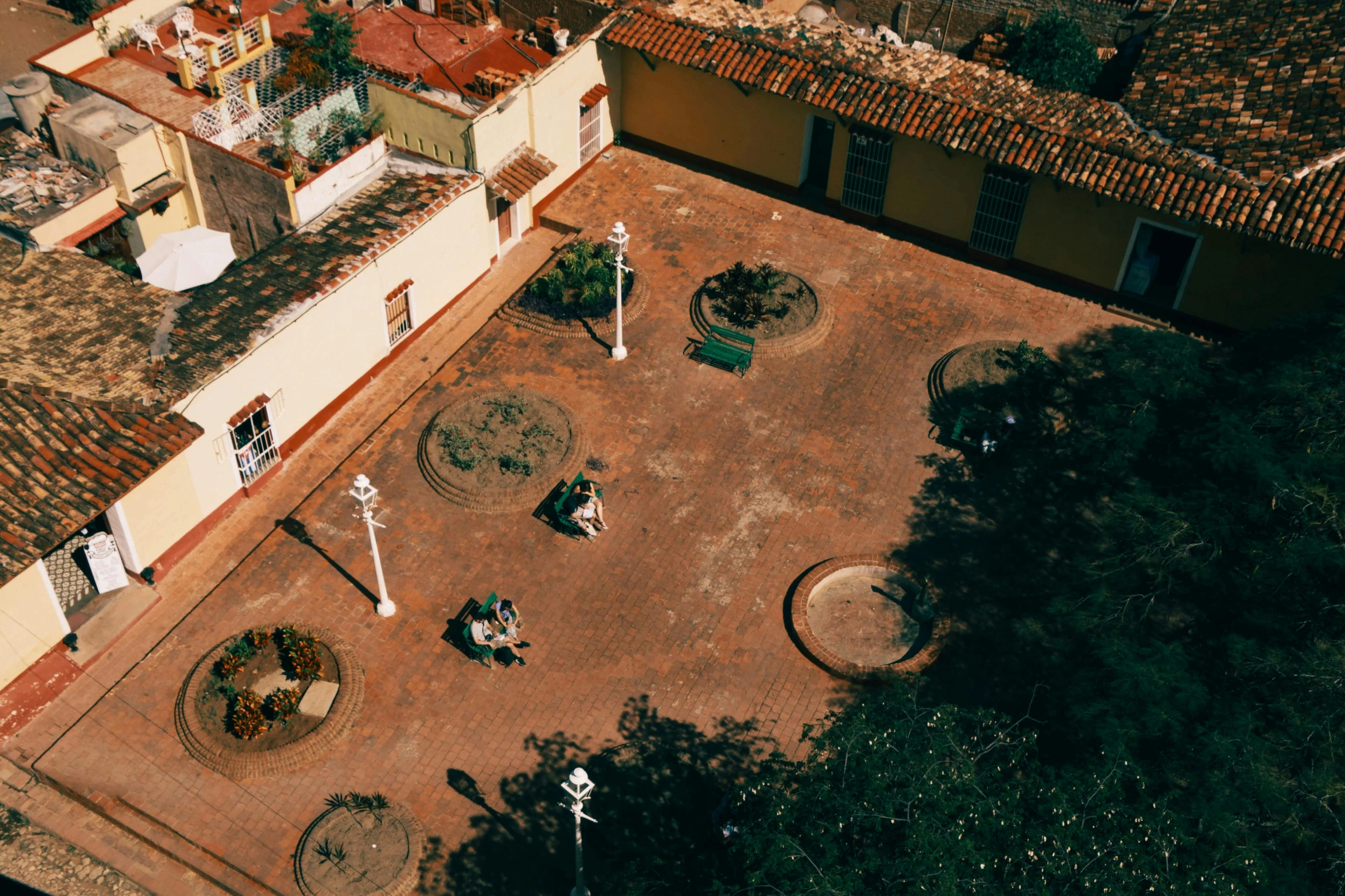 a couple of men standing on top of a brown roof