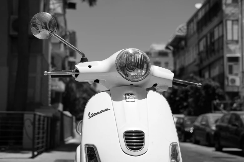 a scooter is sitting in front of a sidewalk