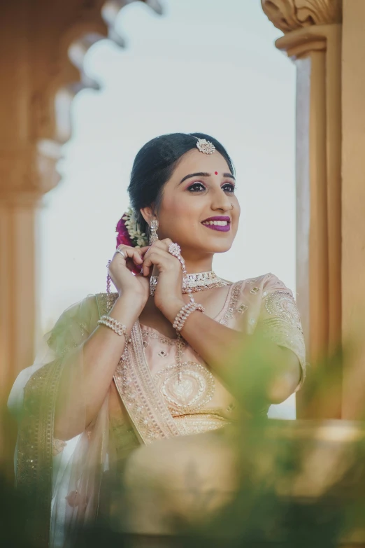 an indian bride wearing traditional saree with flower in hair