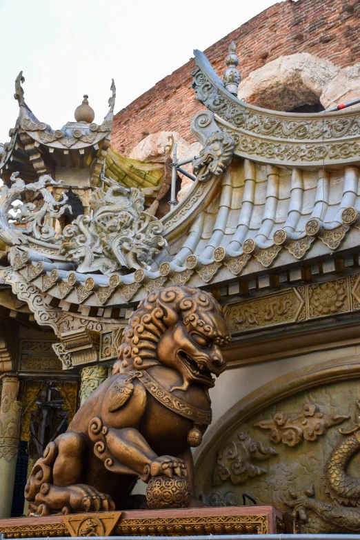 two stone lions with sculptures at the entrance