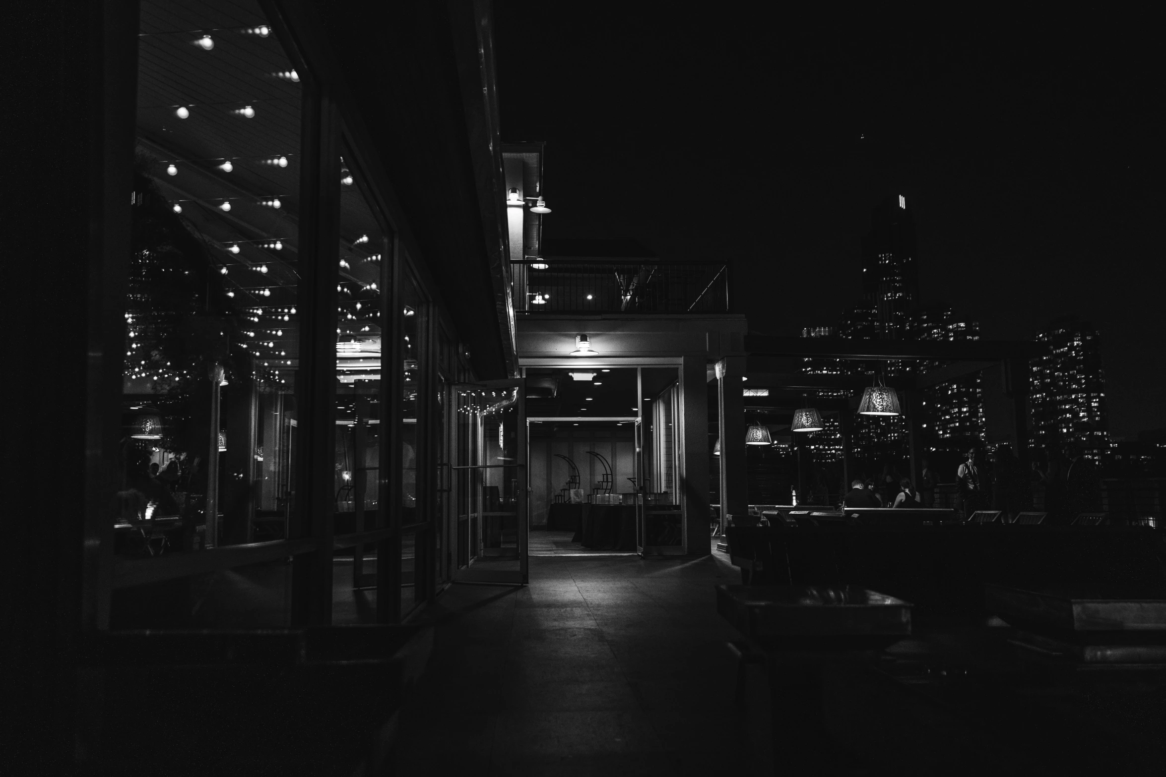 dark night and light in the city, with an image looking down a sidewalk