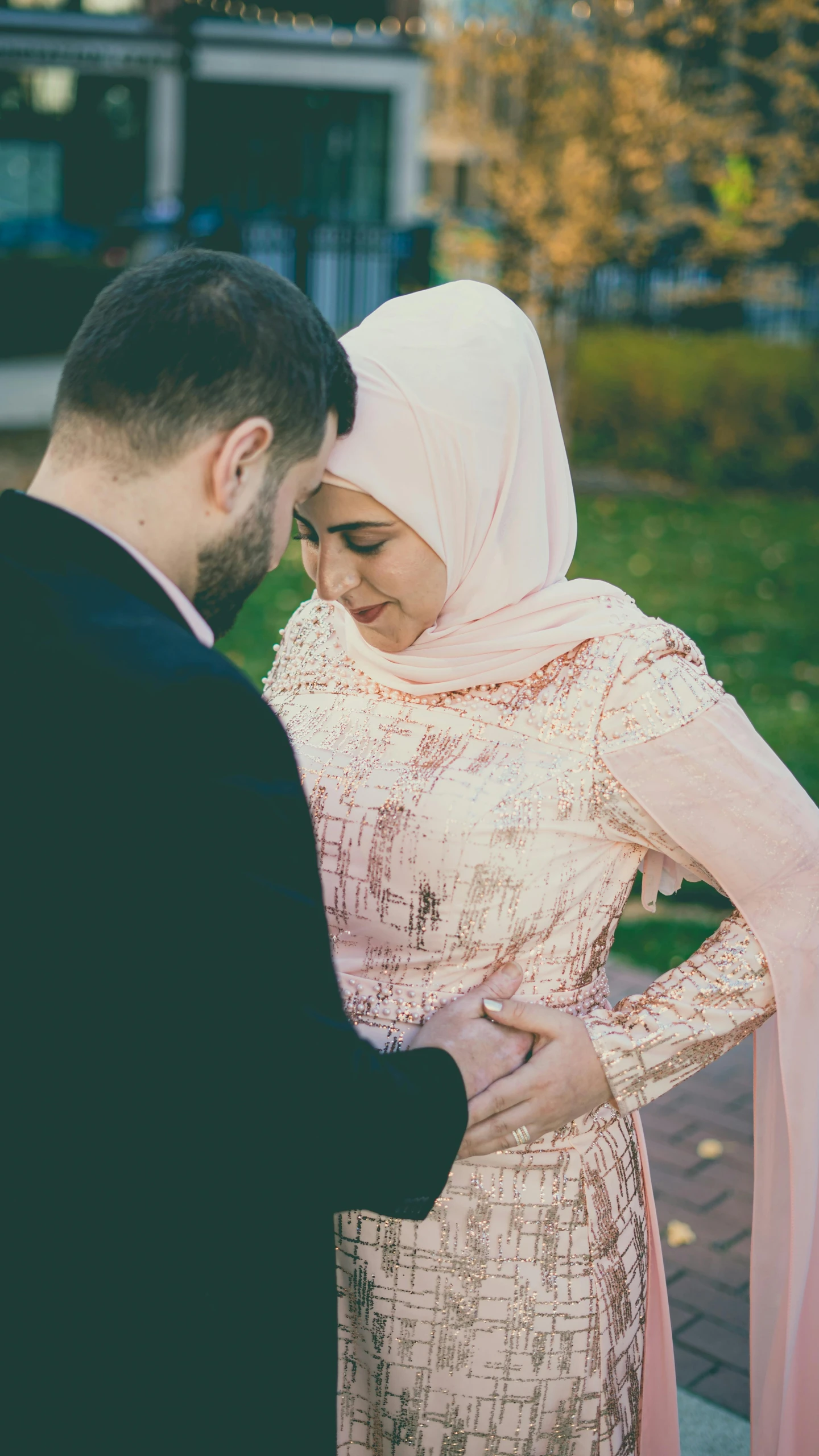 a man and woman in formal wear standing outside