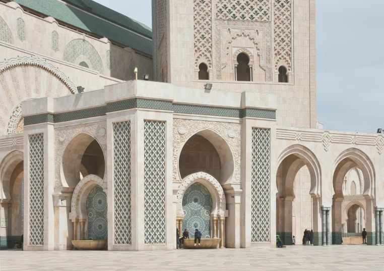 the side of an arabic building with arched doors