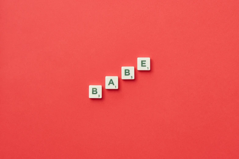 spelled with scrabble blocks on red background
