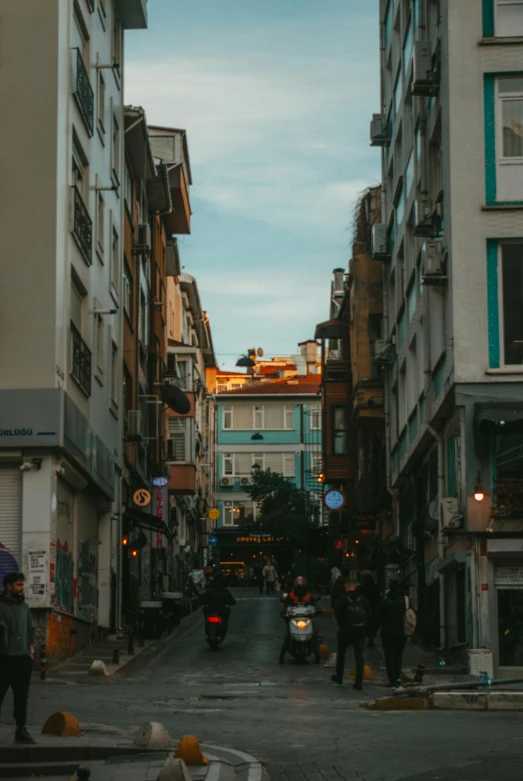 a city street has pedestrians, vehicles, and people on it