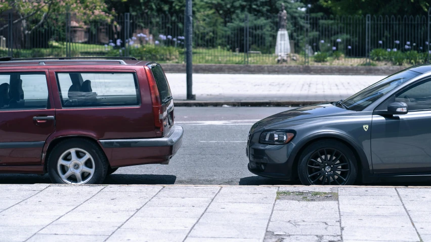 two cars side by side on a city street