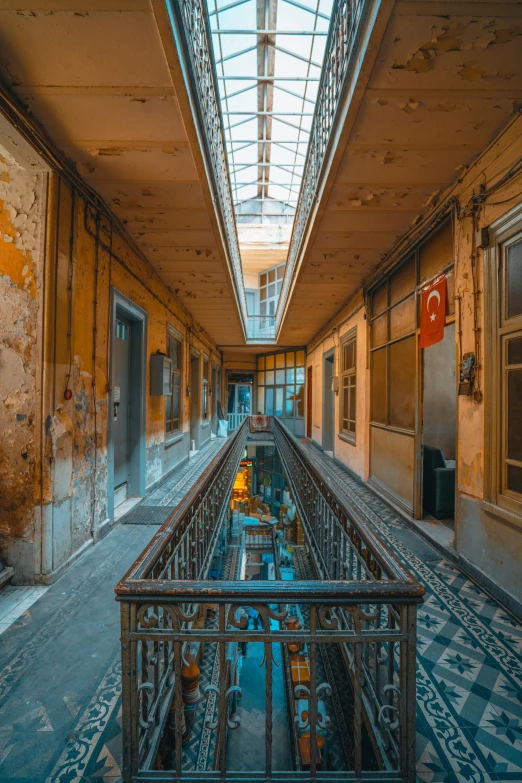 an empty walkway inside of a building with windows