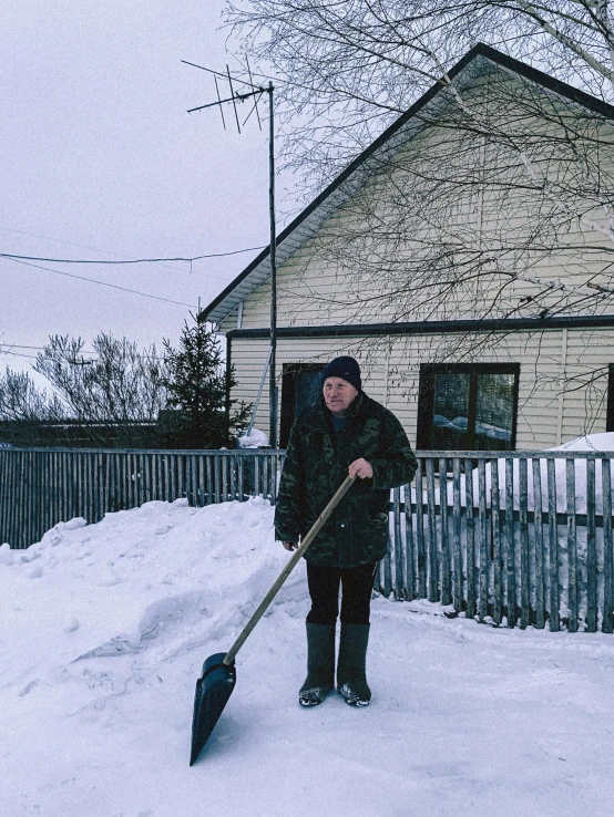 a man shoveling out snow with a snow shovel