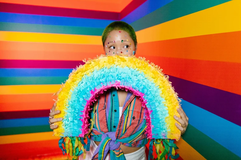 a child dressed in a fake rainbow fan