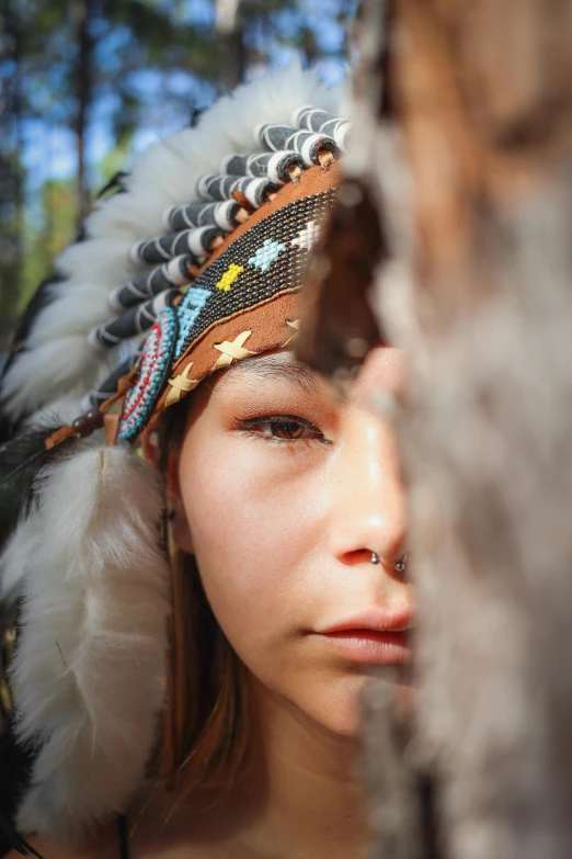 a woman with a headdress looking into the distance