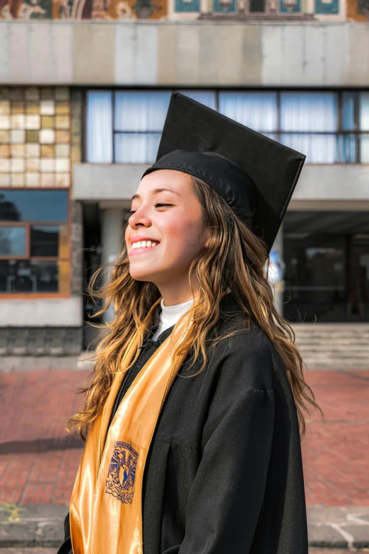 a  wearing a graduation gown and hat