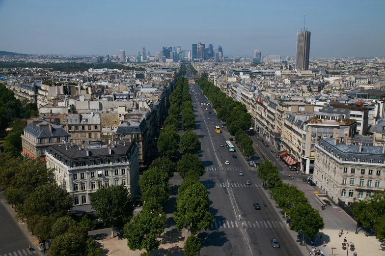 view of paris looking down on a road through the woods