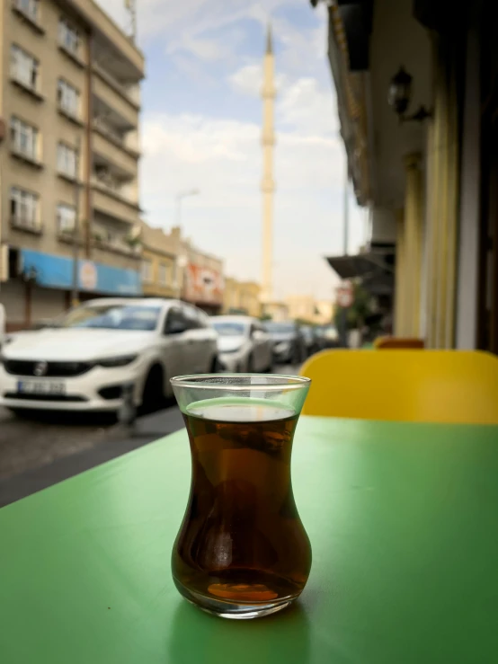 a small glass cup filled with coffee sitting on a table