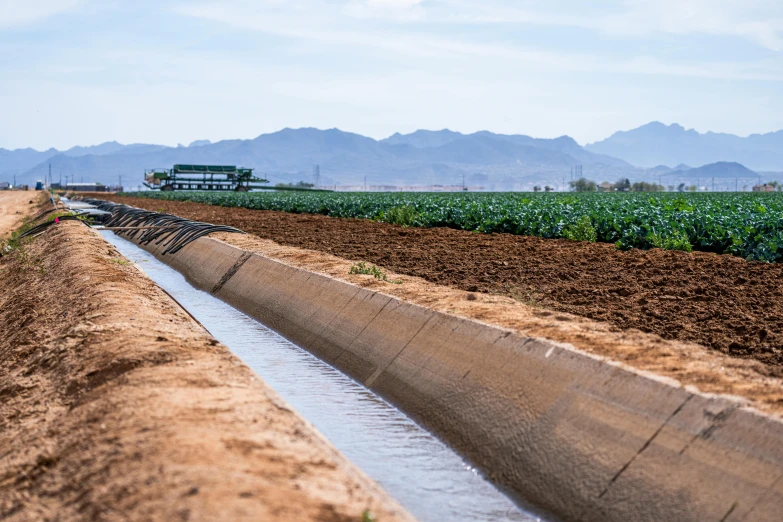 a ditch that is beside a small farm