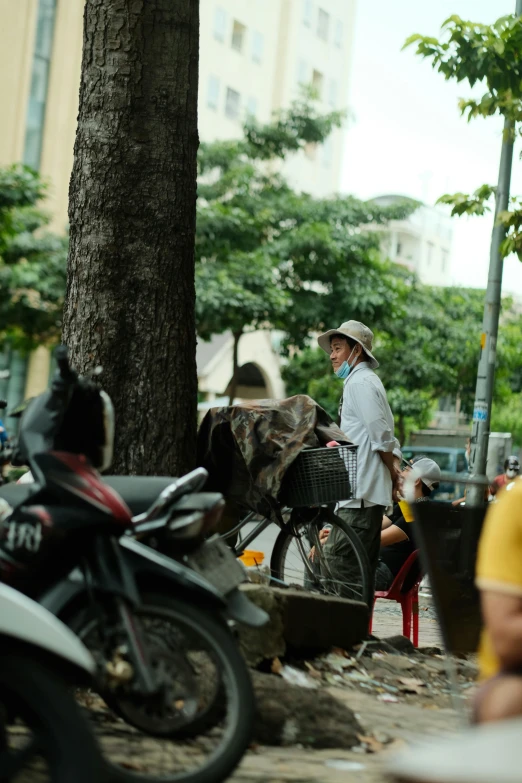 people on street with man and cow on bike