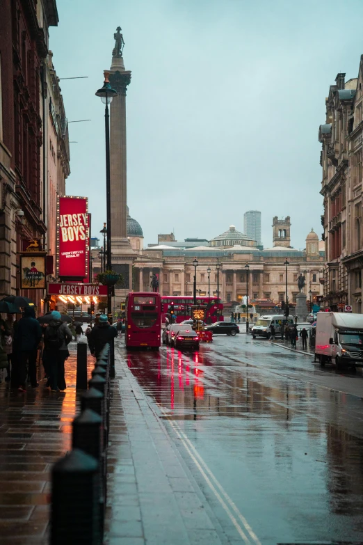 people with umbrellas are standing on the sidewalk outside in the rain