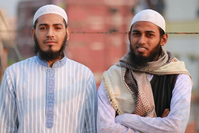 two young men dressed in traditional clothing posing for a picture